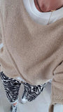 Pull croisé doré brillant
